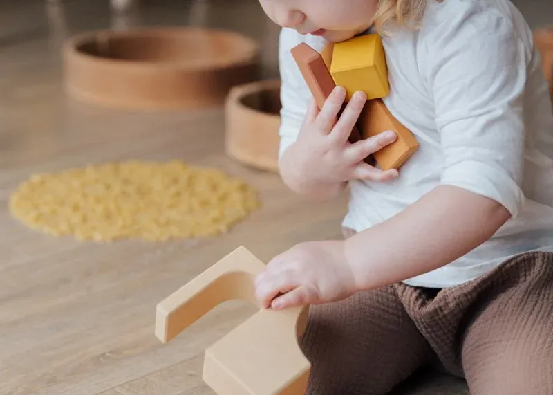 Child playing with wooden blocks