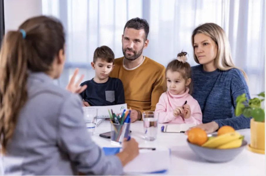 A clinician meeting with a family to discuss assessment results